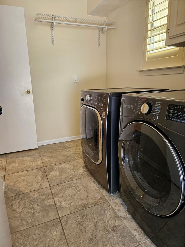 Washroom with washing machine and clothes dryer and cabinet space | Image 18