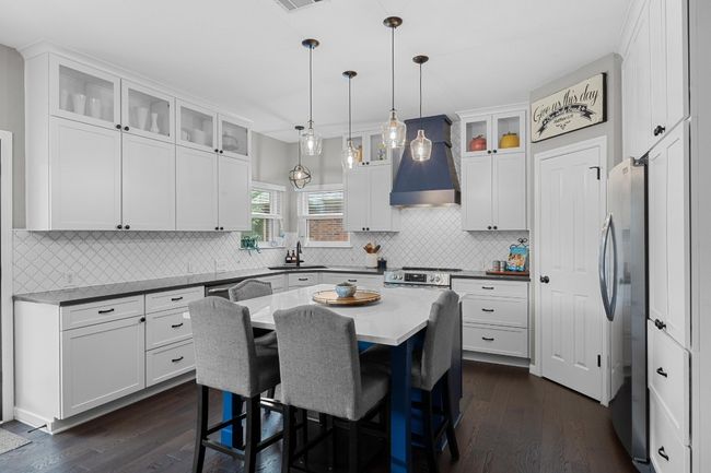 Meticulously remodeled kitchen with oversized island and dramatic vent​​‌​​​​‌​​‌‌​‌‌​​​‌‌​​‌‌​‌​​​​​‌ hood. | Image 14