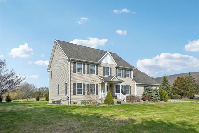 Colonial inspired home featuring roof with shingles and a front yard | Image 46
