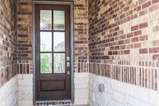 View of exterior entry featuring brick siding | Image 4
