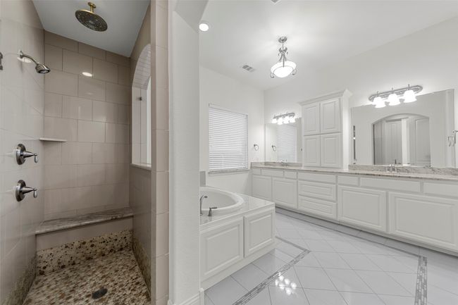 Full bathroom with a walk in shower, tile patterned floors, a bath, and visible vents | Image 21