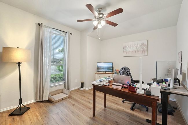 Office featuring ceiling fan and light wood-style flooring | Image 13