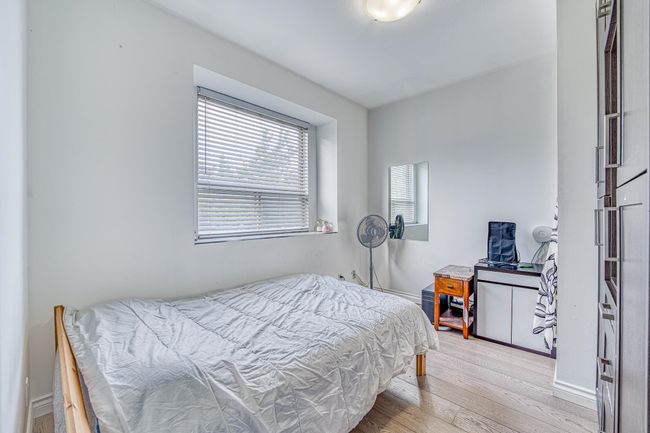 Bedroom featuring wood finished floors and baseboards | Image 12