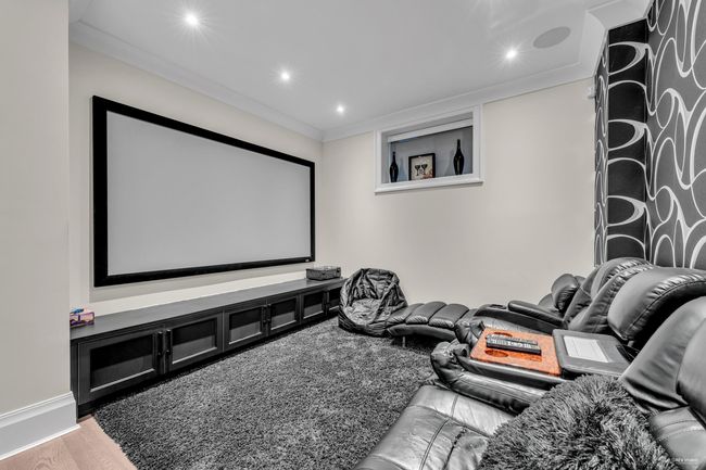 Home theater with light wood-style flooring, recessed lighting, and crown molding | Image 18