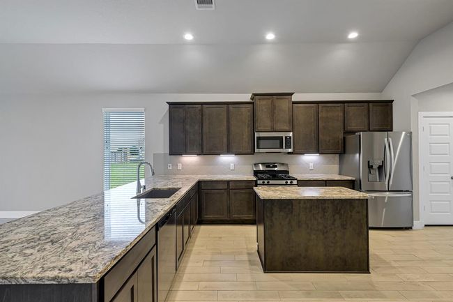 Spacious kitchen with beautiful finishes. Fridge conveys. | Image 10