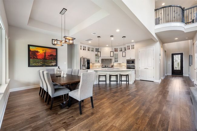 Dining space with dark wood-style floors, a chandelier, and recessed lighting | Image 11