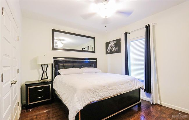 Bedroom featuring ceiling fan and dark hardwood / wood-style floors | Image 25