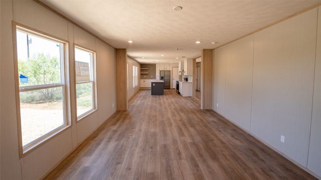 Unfurnished living room featuring light wood-style floors and recessed lighting | Image 12