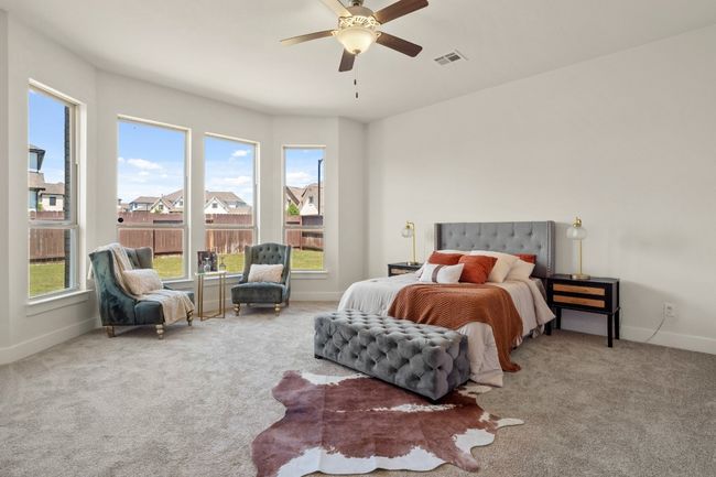 Carpeted bedroom featuring visible vents, baseboards, and ceiling fan | Image 14