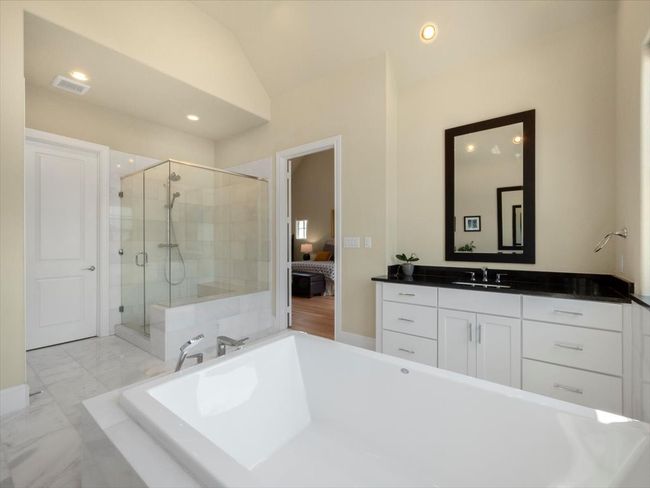 Full bathroom featuring a freestanding bath, ensuite bathroom, a shower stall, vanity, and recessed lighting | Image 12