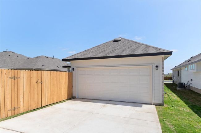 Garage featuring cooling unit and fence | Image 32