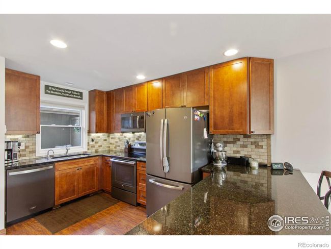 The updated kitchen has a new Pella window that can used to pass food and drinks to friends relaxing on the front deck. | Image 5