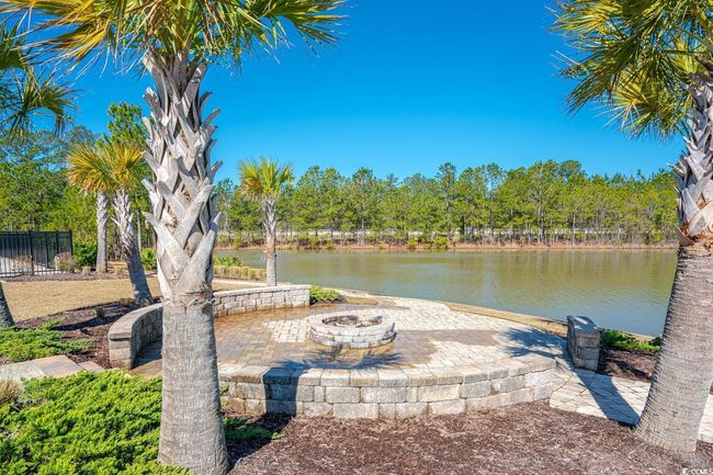 Dock with an outdoor fire pit, a water view, a patio area, and fence | Image 39