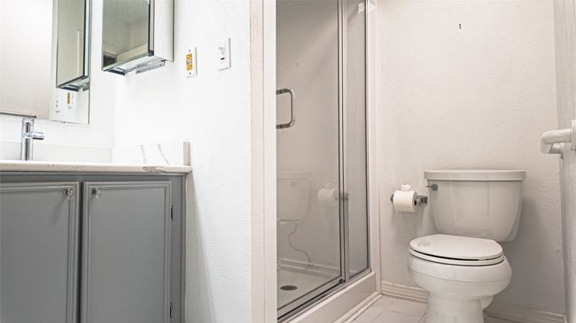 Bathroom featuring a shower stall, vanity, and toilet | Image 31
