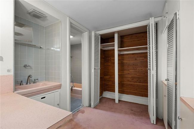 Full bathroom featuring vanity, and closets. | Image 17