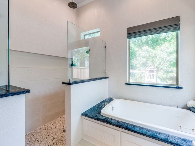Full bathroom featuring a bath and a walk in shower | Image 13