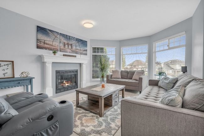 Living room with a glass covered fireplace | Image 4