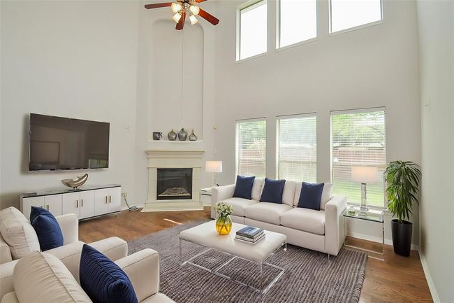 TWO STORY HIGH CEILING DEN WITH CORNER CASTSTONE FIREPLACE | Image 7