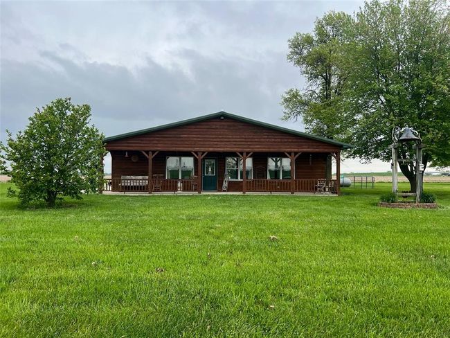 Front of property featuring covered porch and a lawn | Image 25