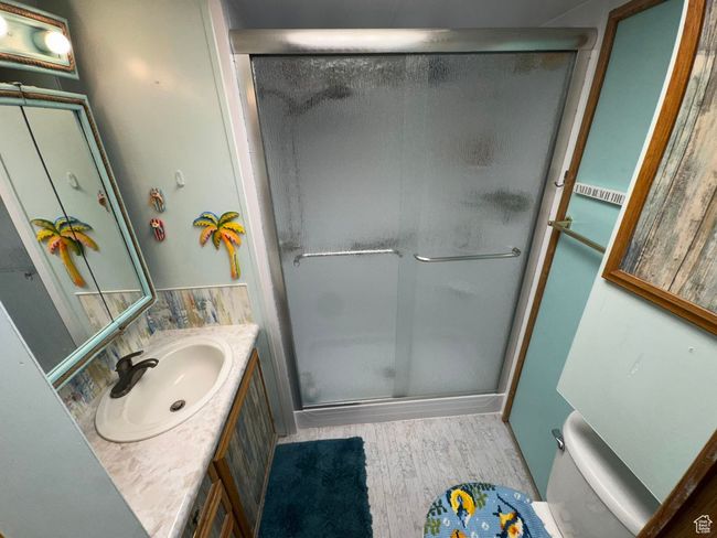 Bathroom featuring wood finished floors, vanity, and a stall shower | Image 17