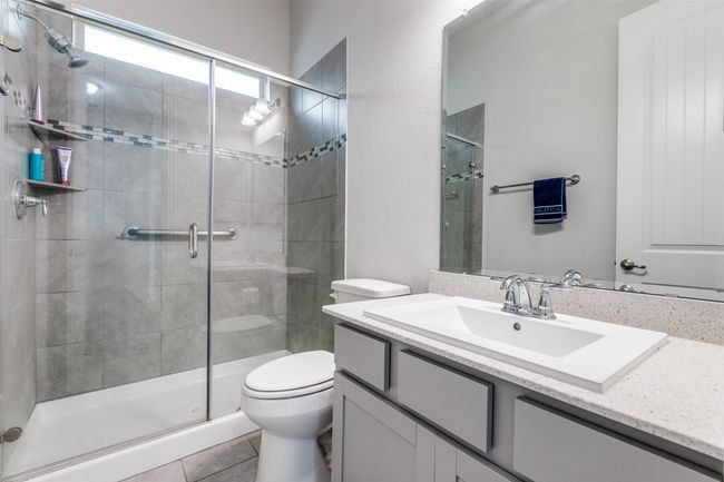 Full bath with vanity, toilet, a stall shower, and tile patterned flooring | Image 17
