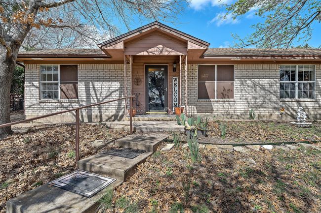 View of front of house with a shingled roof and brick siding | Image 5