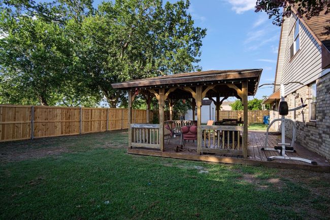 Fenced backyard with a gazebo and a deck | Image 24