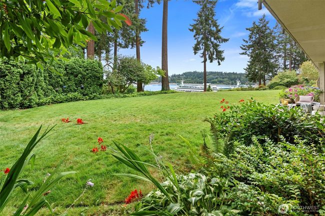 A spacious lawn leads to seating area toward ferry | Image 22