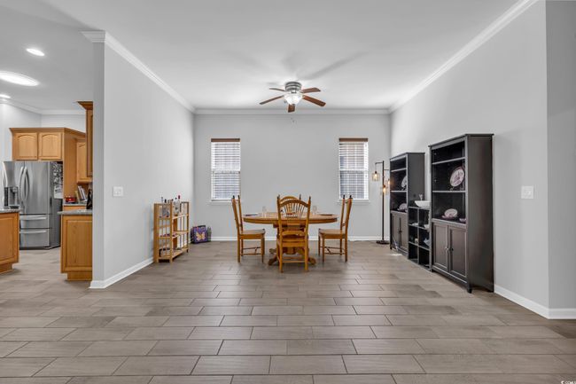 Dining area with ceiling fan and crown molding | Image 17