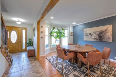 Dining area with plenty of natural light, light hardwood / wood-style floors, and crown molding | Image 3