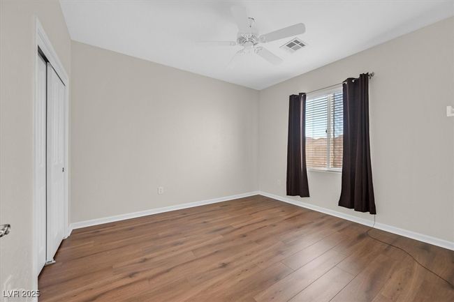 bedroom featuring baseboards, LVP flooring and a ceiling fan | Image 21