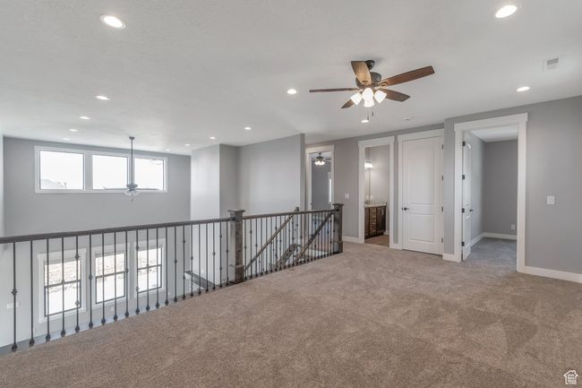 Carpeted spare room featuring a ceiling fan and recessed lighting | Image 23