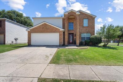 Front facade with a front lawn and a garage | Image 3