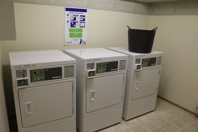 Communal laundry room featuring separate washer and dryer and light tile patterned floors | Image 20