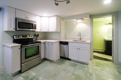 Recently renovated kitchen with granite counters and new custom cabinetry. | Image 3