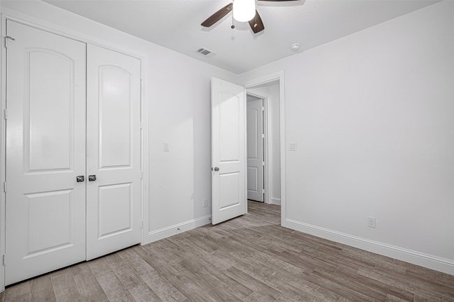 Unfurnished bedroom featuring light wood-type flooring, baseboards, a closet, and a ceiling fan | Image 16