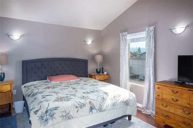 Bedroom featuring wood finished floors and lofted ceiling | Image 43