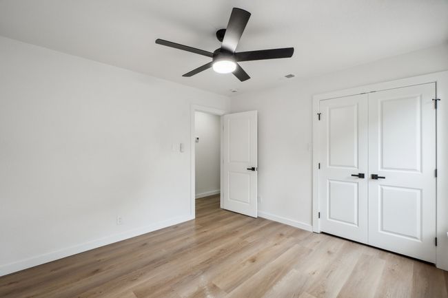 Unfurnished bedroom featuring light wood-style flooring, baseboards, a closet, and a ceiling fan | Image 28