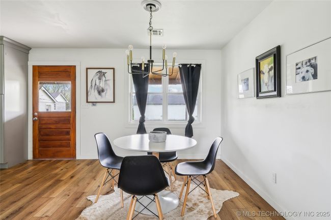Dining room featuring a chandelier, hardwood / wood-style floors, and baseboards | Image 17