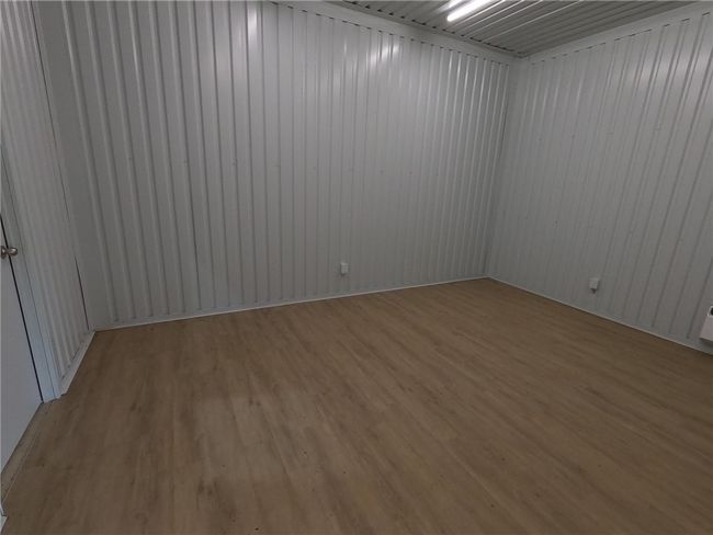 Empty room with wood finished floors and wood walls | Image 10