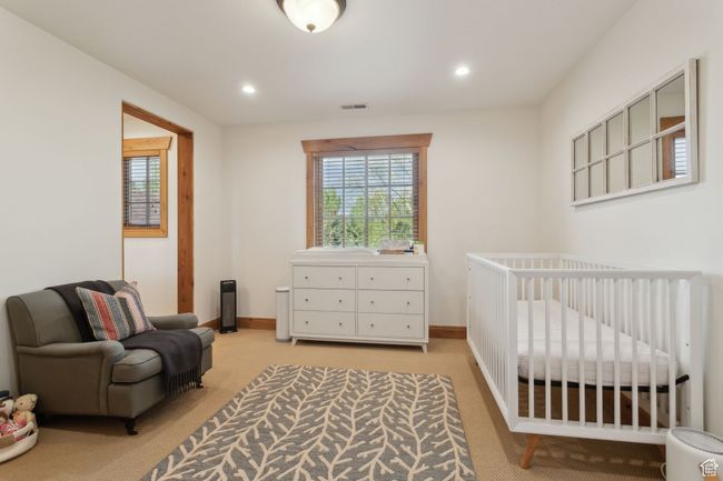 Bedroom with light colored carpet, recessed lighting, a nursery area, and baseboards | Image 37