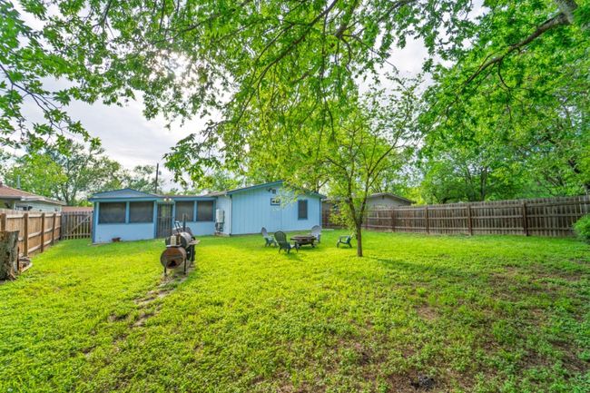 Fenced backyard featuring a sunroom | Image 33