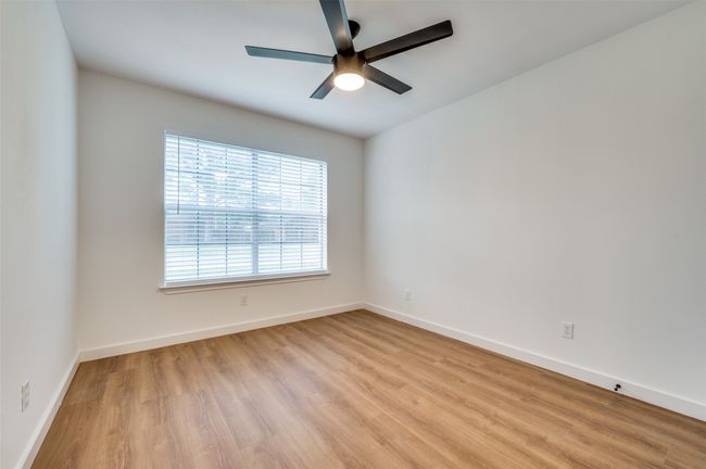 Spare room with wood finished floors, baseboards, and a ceiling fan | Image 21