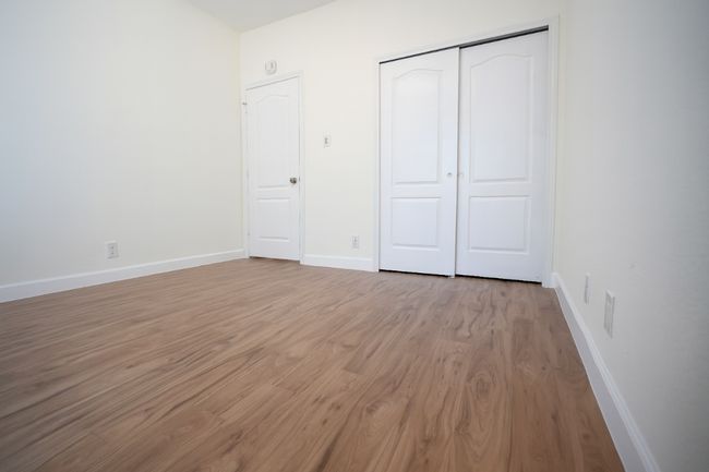 First floor bedroom featuring wood finished floors and a closet | Image 16