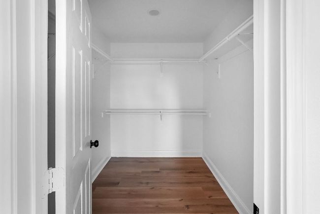 Spacious closet featuring wood finished floors | Image 14