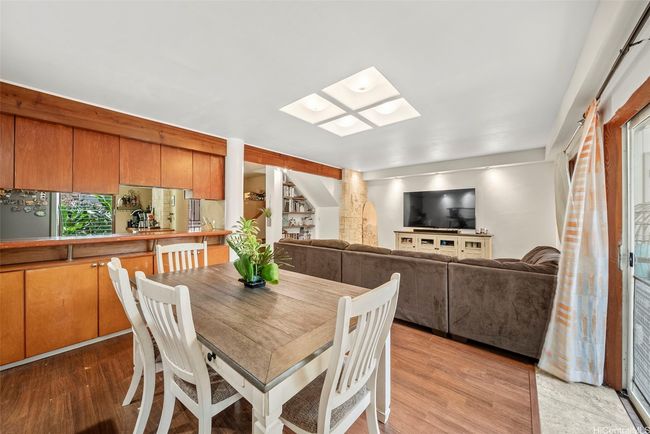 Dining looking towards living area with kitchen to the left (check out that storage space). | Image 8