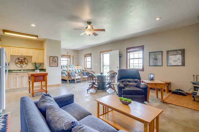 Living area with concrete flooring, ceiling fan, and recessed lighting | Image 27