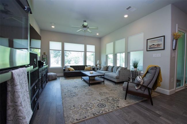 This spacious living room features abundant natural light. | Image 5