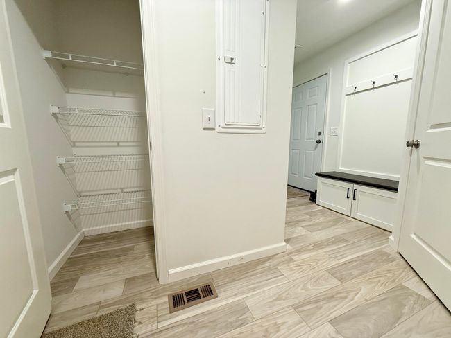 Laundry room with bench and large closet | Image 9