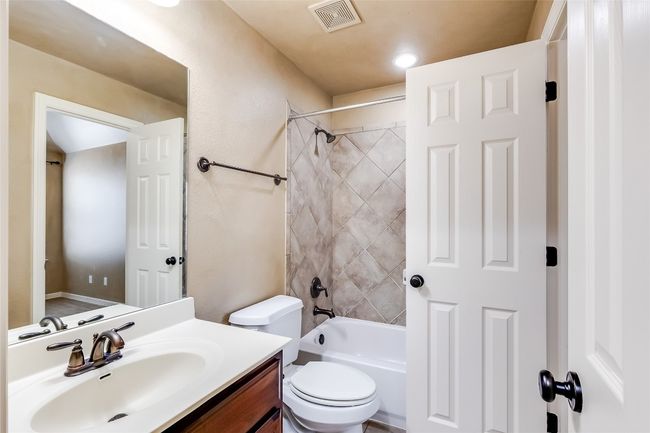 Full bathroom with shower / bath combination, visible vents, toilet, and vanity | Image 33